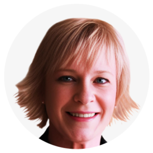 A person with short blonde hair and a smile.