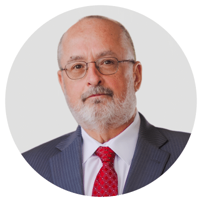 A man with glasses, a beard, and a suit with a red tie. A man with glasses, a beard, and a suit with a red tie.
